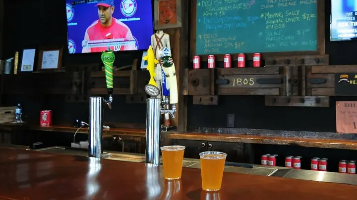 The bar with beer taps and two beers poured