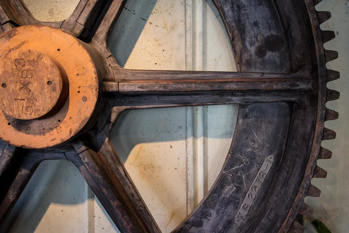 An old iron gear wheel on the wall