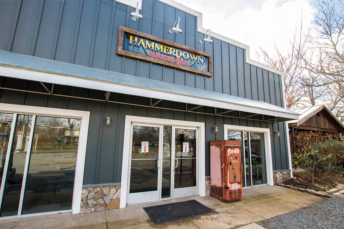 The front of Hammerdown Barbeque: slate siding, the sign and an old Coca-Cola machine by the door